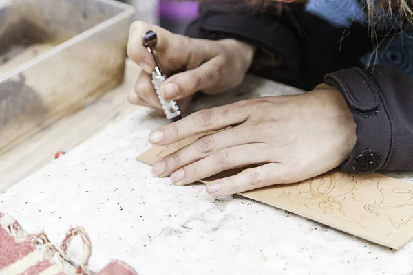 Leather worker, detail of a handicraft worker, hands