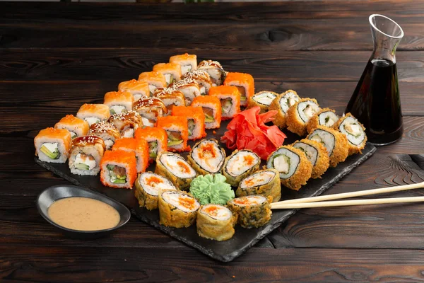 Sushi Set Omáčkou Hůlkami Černé Desce Tmavém Dřevěném Pozadí Stock Snímky