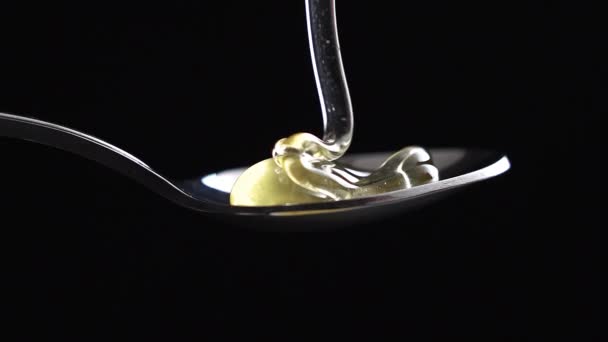 Honey dripping from honey dipper black background close up slow motion — Stock Video