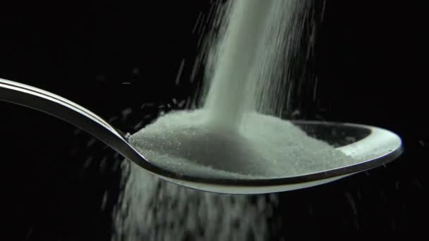 White sugar fall down into a spoon — Stock Video