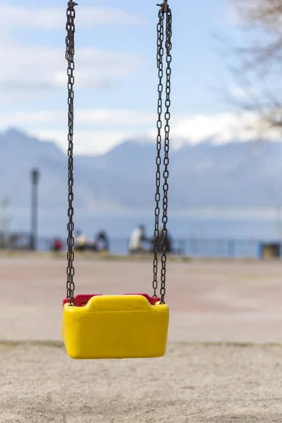 Empty swing with yellow and red colors — 스톡 사진