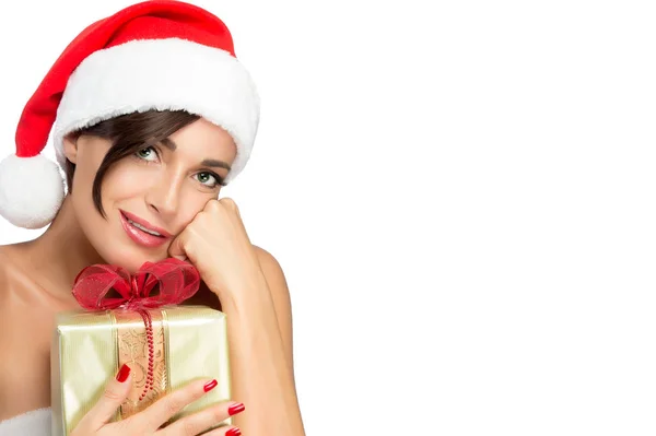 Smiling woman in Santa hat with a Christmas present — Stock Photo, Image