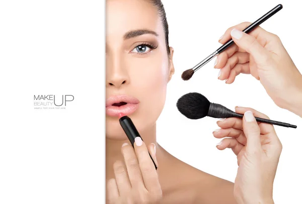 Beautiful model girl in make up process with makeup brushes — Stock Photo, Image