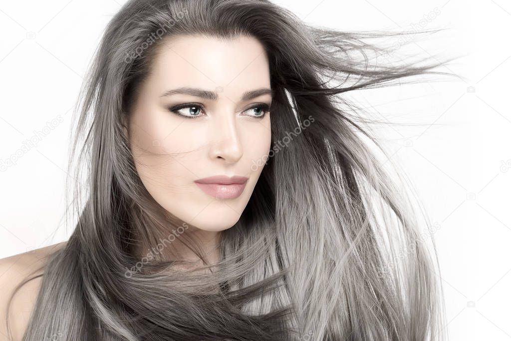 Young woman with long trendy silver hair. Care and hair products