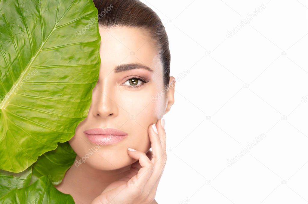 Skin care concept with a young beautiful woman touching her face