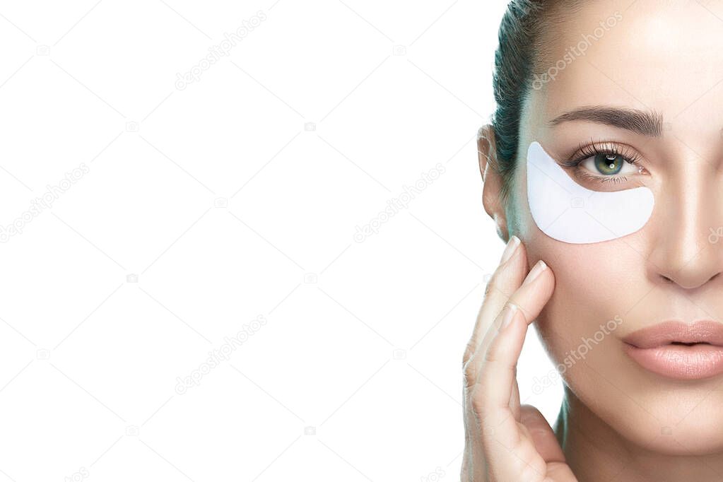 Cosmetic eye mask. Healthy skin woman using eye patches. Beauty and skin care concept. Closeup beauty face woman with fresh clean skin using eye pads. Eye care treatment. Isolated on white. Copy space