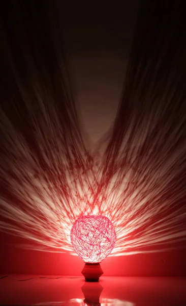 Duvarında gölgeler olan el yapımı ahşap ve halat lambası.