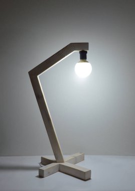 Gri arkaplanda el yapımı ahşap lamba