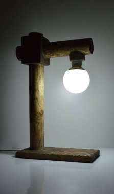 Gri arkaplanda el yapımı ahşap lamba 