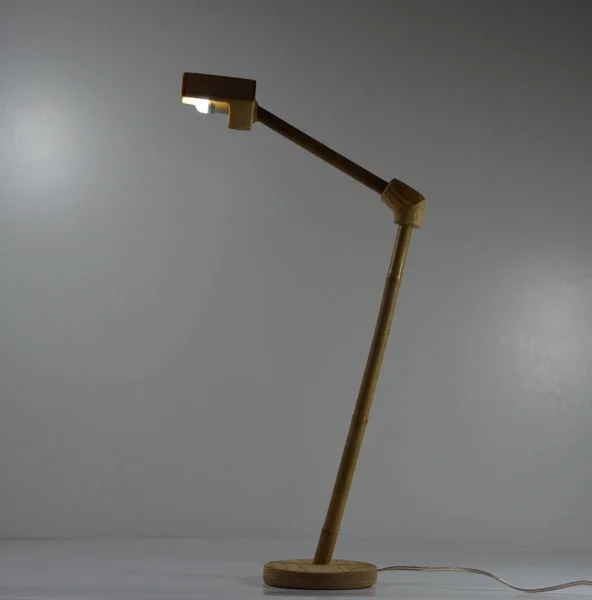 Handmade wood and bamboo desk lamp on gray background