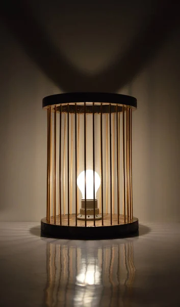 Handmade wooden lamp with bamboo sticks shade on dark gray background