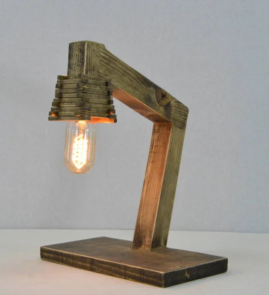 Handmade wooden lamp on gray background