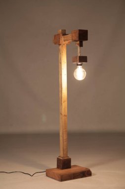 Gri arkaplanda el yapımı ahşap lamba