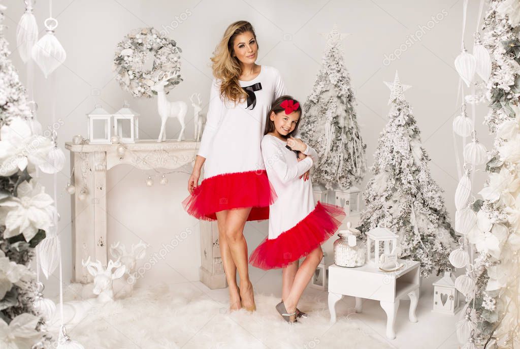 mother and daughter  in Christmas scenery. 