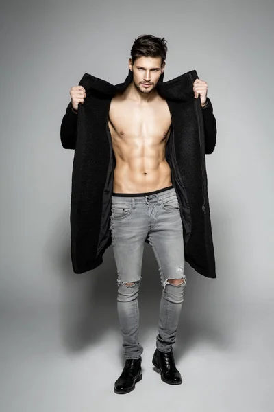 Man showing his chest in black coat — Stock Photo, Image