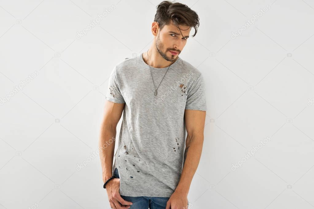 man in black t-shirt flirting at camera