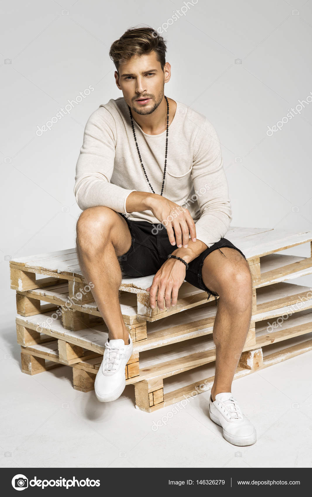 Charismatic young man sitting on chair in the... - Stock Photo [102597431]  - PIXTA