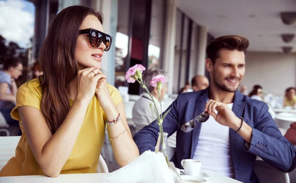 Beautiful couple sitting in restaurant — Stock Photo, Image