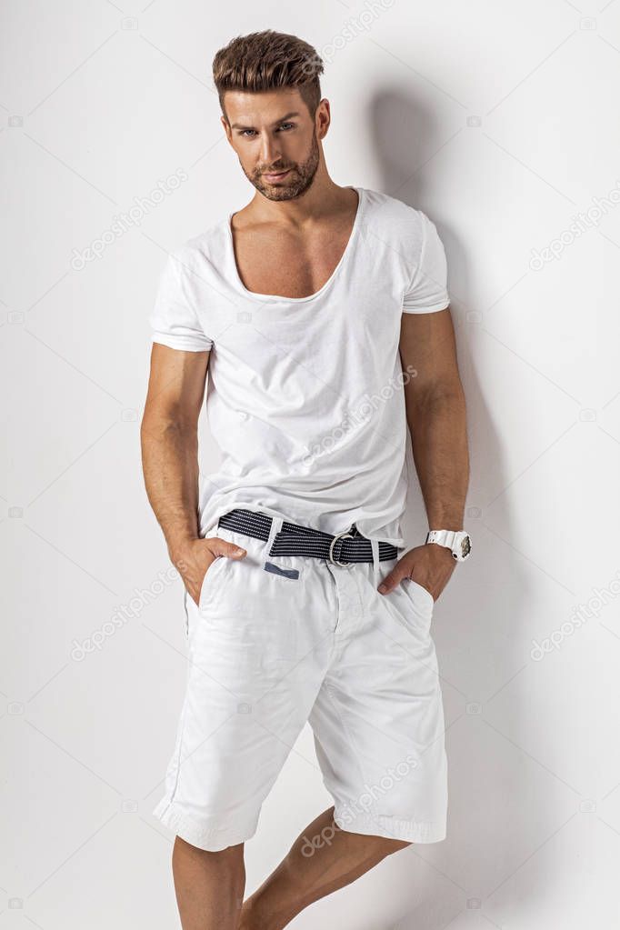 man with hands in pockets posing