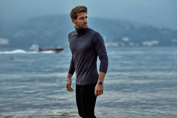 Hombre guapo en ropa de moda caminando por la playa —  Fotos de Stock