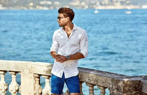 Retrato de un hombre guapo con elegante camisa blanca y sunglas — Foto de Stock