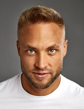 Face of handsome blond man looking at camera