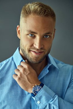 Portrait of handsome man in blue shirt wear watch