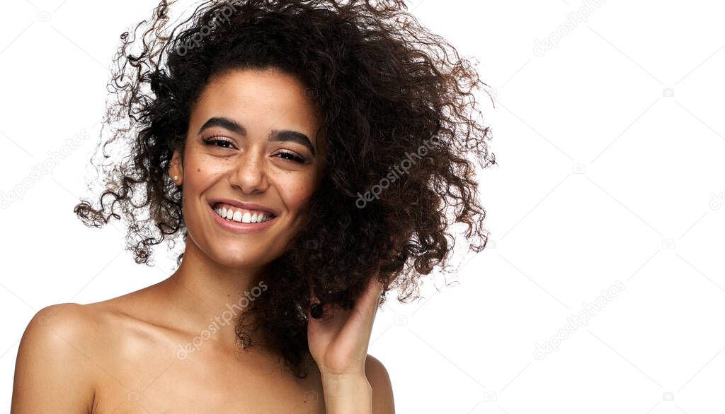 Portrait of beautiful cheerful latin american woman with afro ha
