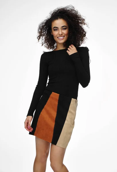 Cheerful latin american woman wear short skirt with afro hairsty — Stockfoto