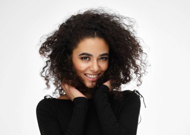 Latin american woman touching her afro hairstyle isolated on whi