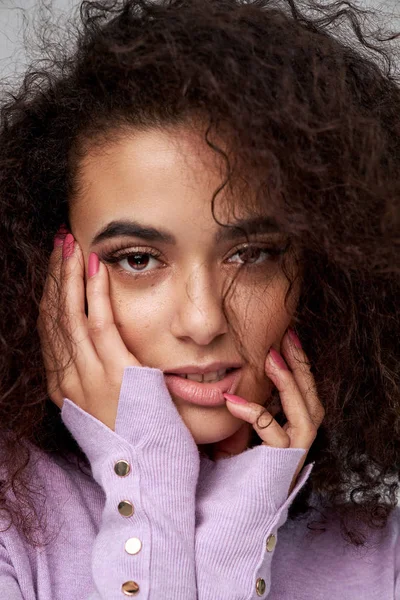 Portrait of latin american woman with freckles and afro hairstyl