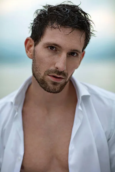 Portrait face of handsome male model with wet hair looking at ca — Stok fotoğraf