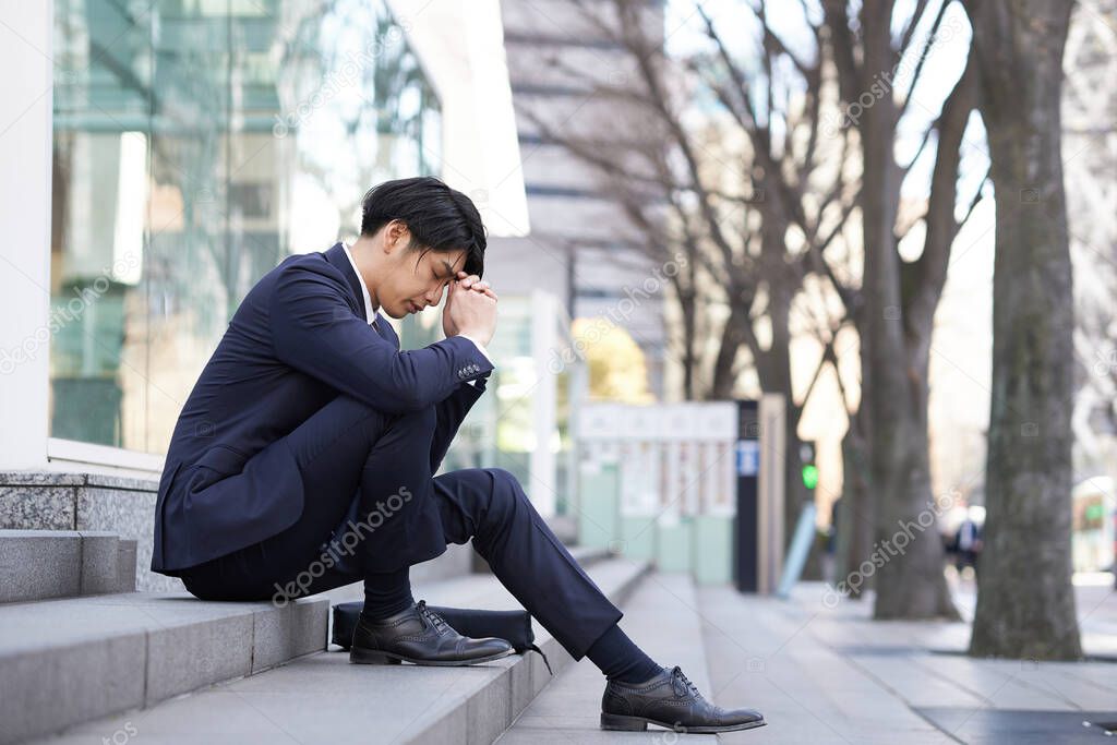 Japanese male businessmen suffering from anxiety.