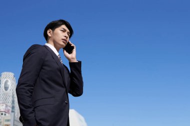 Japon erkek işadamları akıllı telefonlarıyla arama yapıyorlar..