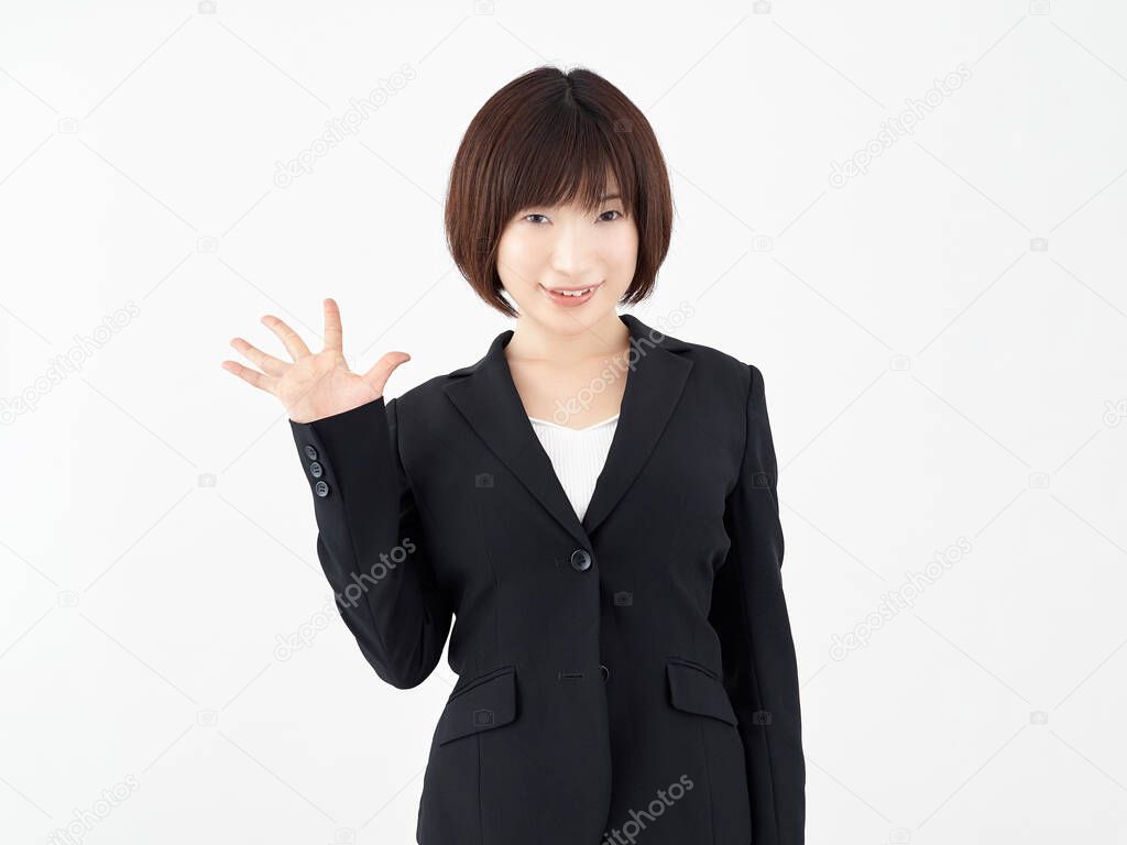 A Japanese female office worker poses with a 5-pointing pose on a white background