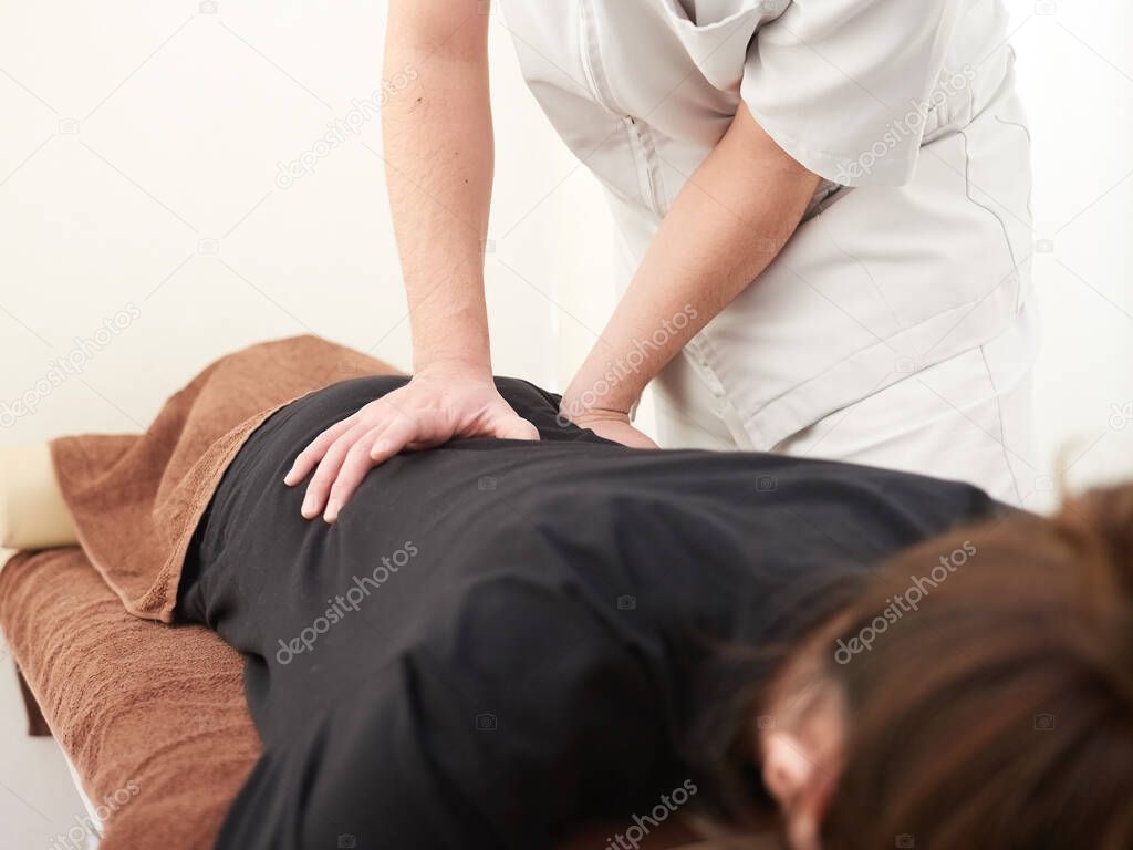 A Japanese woman getting a waist massage