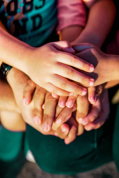 Close up join hands of a family member. A father, mother, daughter and son.