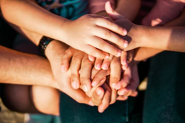 Close up join hands of a family member. A father, mother, daughter and son.