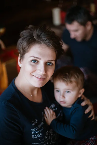 Family New Year. Portrait of mom with baby at the New Year tree