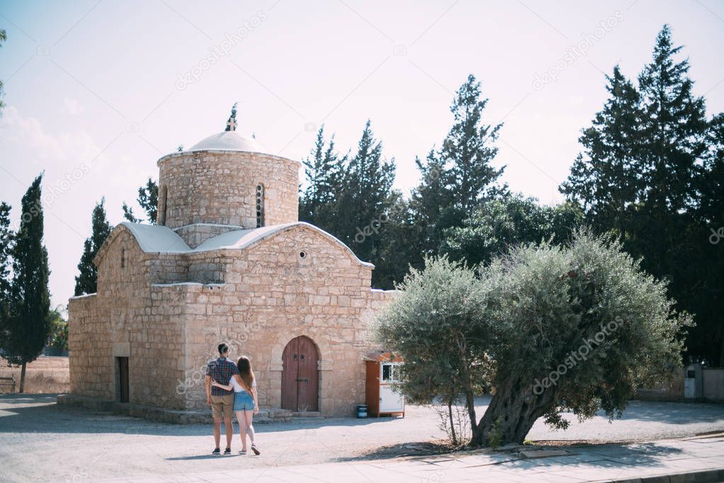 Lovers walk near the ancient temple