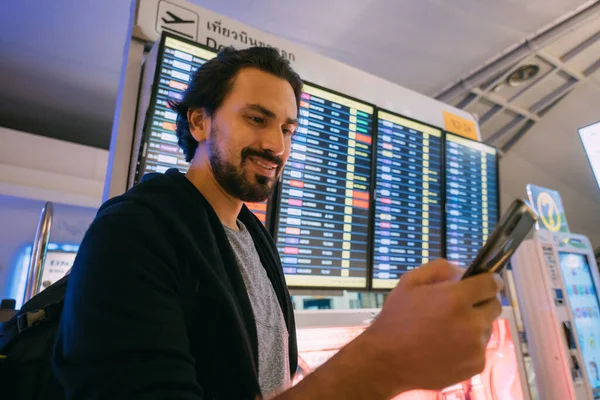 Man Scoreboard Airport Young Guy Backpack Looks Flight Schedule Screen — Stock Photo, Image