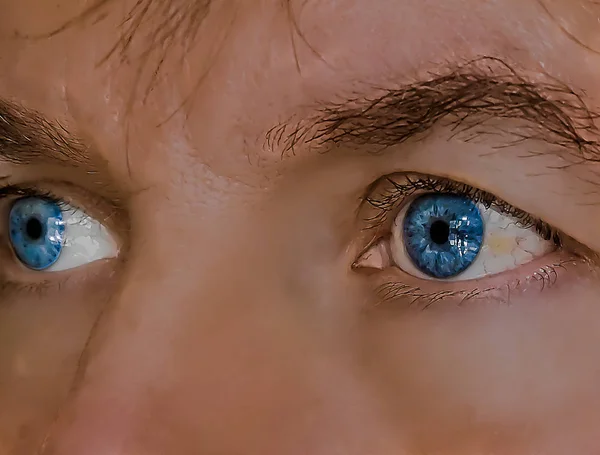Close up of a blue mans eyes