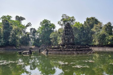 mysterious, mystical sunken temple ruins in ancient angkor wat, jungle reflecting in lake, cambodia
