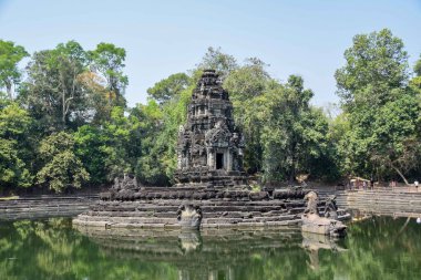 mysterious, hidden, abandoned sunken temple ruins in ancient angkor wat, jungle reflecting in lake, cambodia