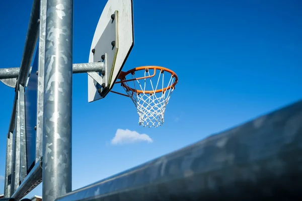 Aro de baloncesto sobre un fondo de cielo azul . — Foto de Stock