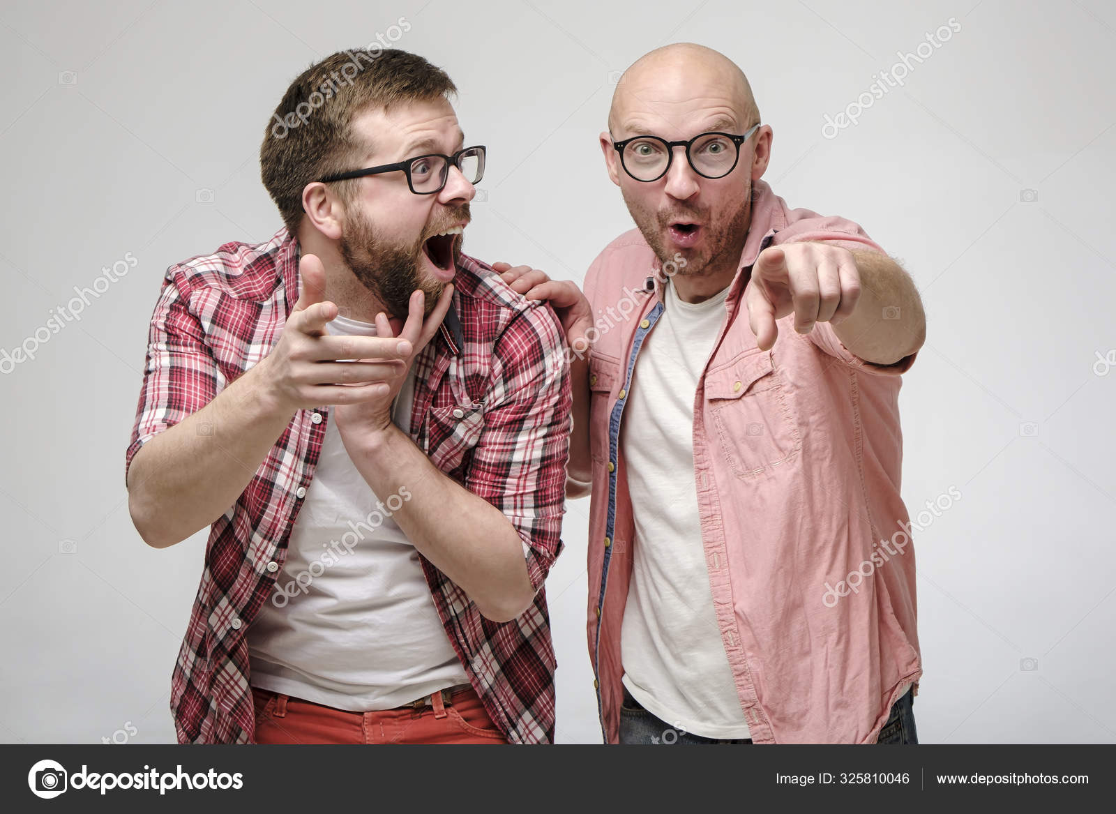 Funny men in glasses point to someone with their hands, they are surprised at what they saw, they are happy and laugh out loud. Stock Photo by ©akoldunov 325810046 Funny men in glasses point to someone with their hands, they are surprised at what they saw, they are happy and laugh out loud. Stock Photo by ©akoldunov 325810046