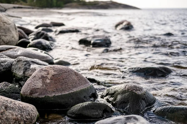 Lungomare roccioso, sullo sfondo del mare con piccole onde, rocce e cielo. Vista dal basso . — Foto Stock