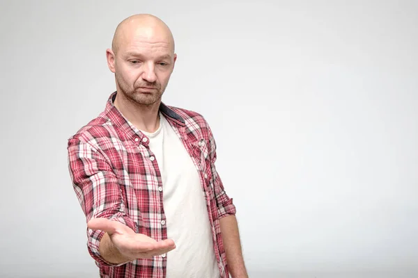 Bad deal. Disgruntled man gives hand for a handshake and looks sadly down, with copy space. — 스톡 사진