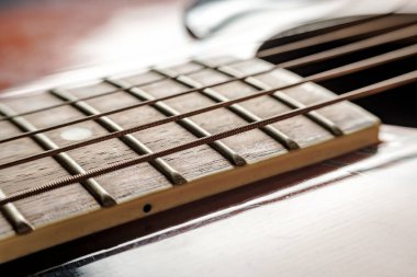 Neck with strings and body, close-up, on an old, classic acoustic guitar.