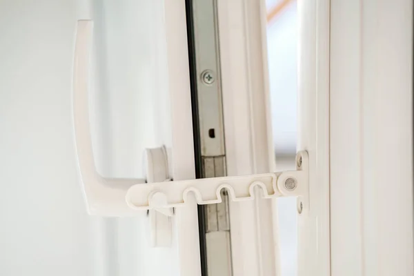 Open white PVC window with a fixing device for ventilation. Close-up. — 스톡 사진